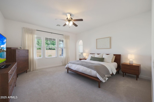 20834 W Prospector Way, Buckeye, AZ 85396 - bedroom featuring light colored carpet, arched walkways, baseboards, and a ceiling fan