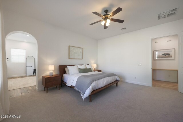 20834 W Prospector Way, Buckeye, AZ 85396 - bedroom featuring arched walkways, carpet flooring, baseboards, and a ceiling fan