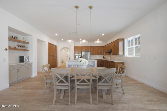 20834 W Prospector Way, Buckeye, AZ 85396 - dining room featuring arched walkways, baseboards, light wood finished floors, and recessed lighting