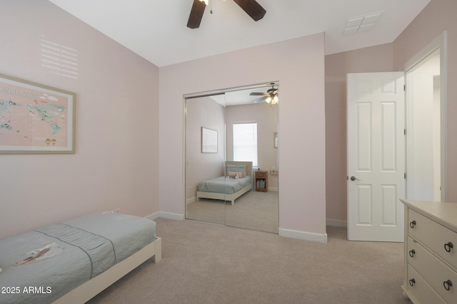 20834 W Prospector Way, Buckeye, AZ 85396 - bedroom featuring light carpet, a closet, a ceiling fan, and baseboards