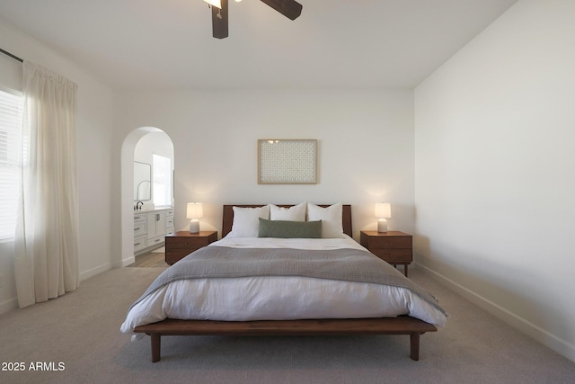 20834 W Prospector Way, Buckeye, AZ 85396 - bedroom featuring arched walkways, baseboards, light colored carpet, and a ceiling fan