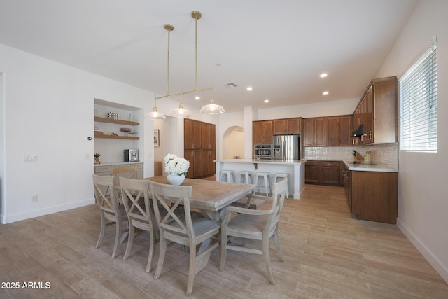 20834 W Prospector Way, Buckeye, AZ 85396 - dining room with arched walkways, light wood-style floors, baseboards, and recessed lighting