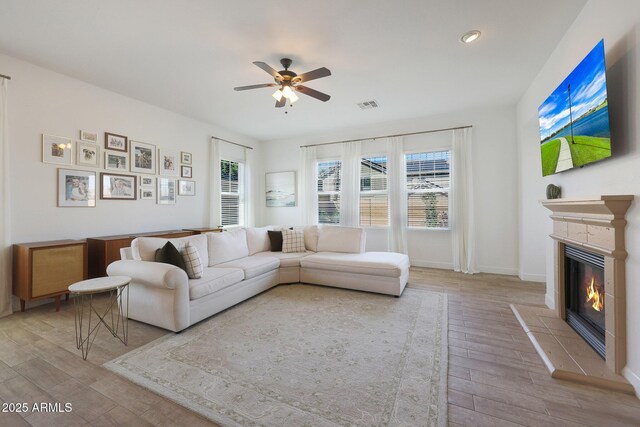 20834 W Prospector Way, Buckeye, AZ 85396 - living room featuring wood finished floors, ceiling fan, a glass covered fireplace, recessed lighting, and baseboards
