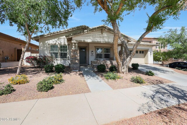 20834 W Prospector Way, Buckeye, AZ 85396 - view of front facade featuring an attached garage, stucco siding, driveway, and a porch