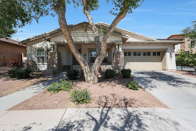 20834 W Prospector Way, Buckeye, AZ 85396 - view of front facade featuring stucco siding, an attached garage, driveway, and stone siding