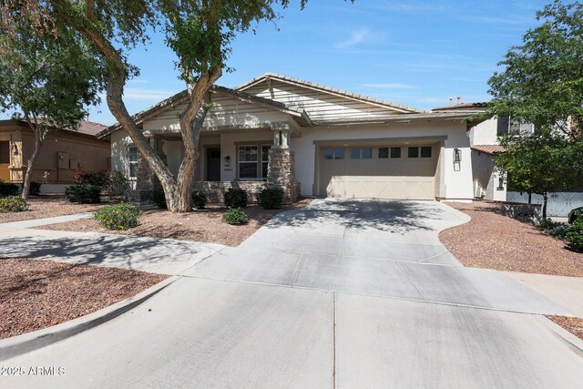20834 W Prospector Way, Buckeye, AZ 85396 - view of front of house featuring a garage, driveway, stucco siding, a tiled roof, and a porch