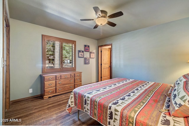 bedroom with a ceiling fan, baseboards, and dark wood-style flooring