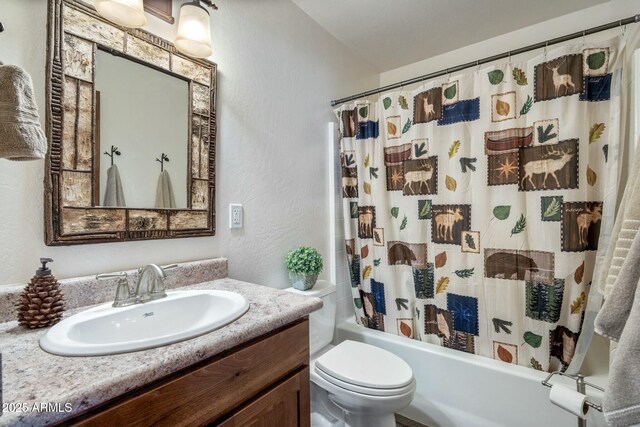 full bathroom with vanity, toilet, shower / bathtub combination with curtain, and a textured wall