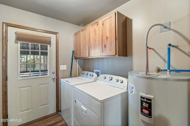 clothes washing area featuring washing machine and clothes dryer, cabinet space, electric water heater, and dark wood-style flooring