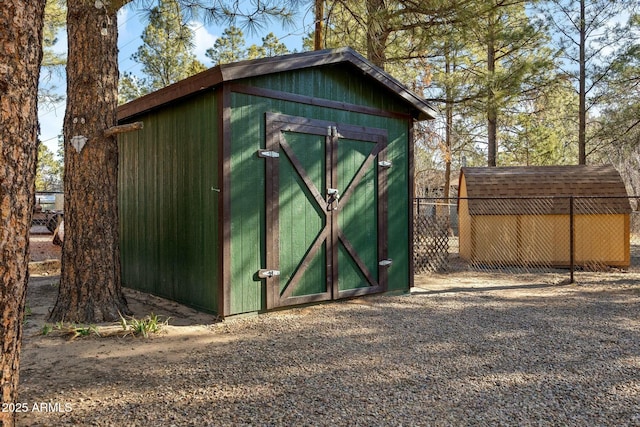 view of shed with fence