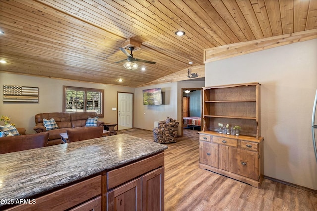 kitchen featuring dark countertops, light wood-style flooring, wooden ceiling, and lofted ceiling