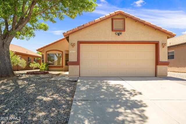 4560 Chaparral Loop, Sierra Vista, AZ 85635 - mediterranean / spanish house featuring concrete driveway, a garage, stucco siding, and a tile roof