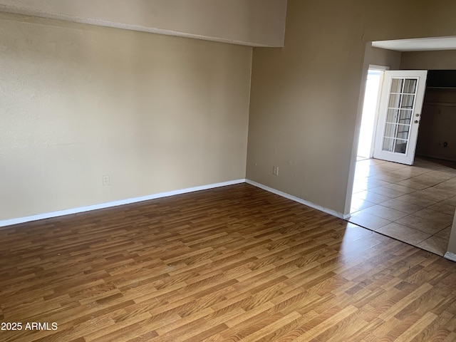 unfurnished room with wood finished floors and baseboards