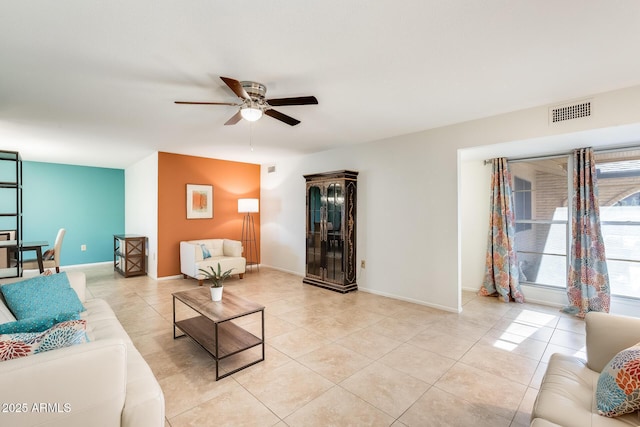 tiled living room featuring ceiling fan