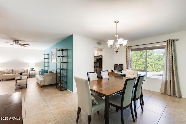 tiled dining space featuring ceiling fan with notable chandelier