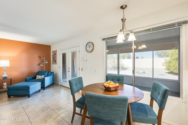 tiled dining area featuring french doors