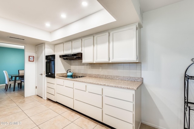 kitchen with white cabinetry, black appliances, tasteful backsplash, and light tile patterned flooring