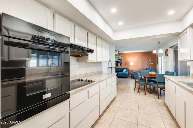 kitchen with ceiling fan with notable chandelier, black appliances, decorative light fixtures, white cabinetry, and light tile patterned floors