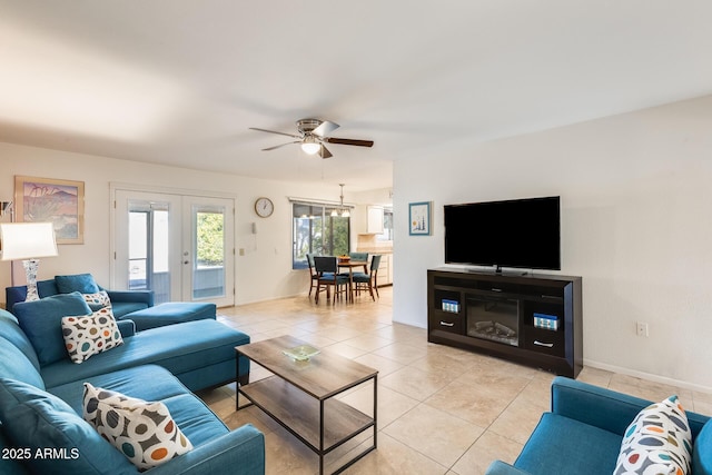 living room featuring ceiling fan, light tile patterned floors, and french doors