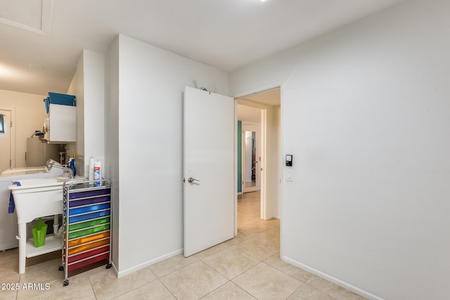 interior space with light tile patterned flooring and sink