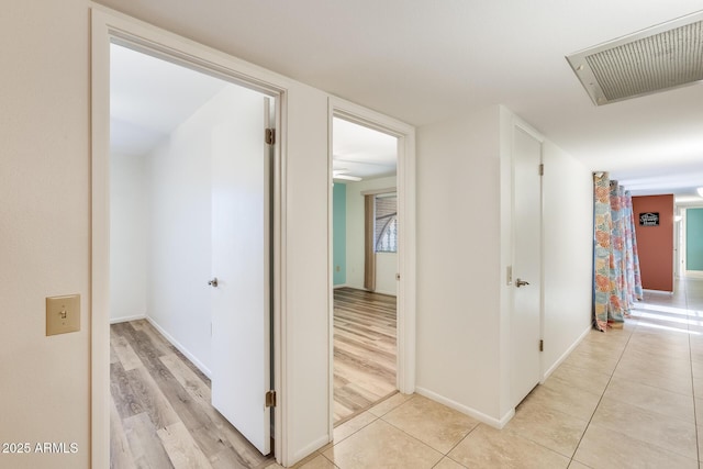 hall with light tile patterned floors