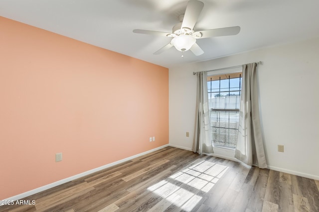 unfurnished room featuring ceiling fan and light wood-type flooring