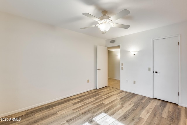 unfurnished bedroom with ceiling fan and light hardwood / wood-style flooring