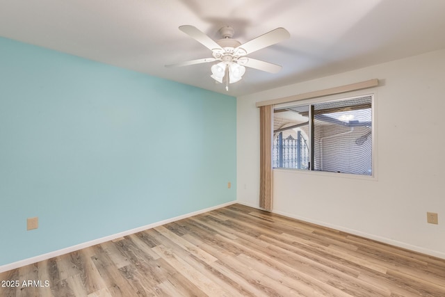 spare room with ceiling fan and light wood-type flooring