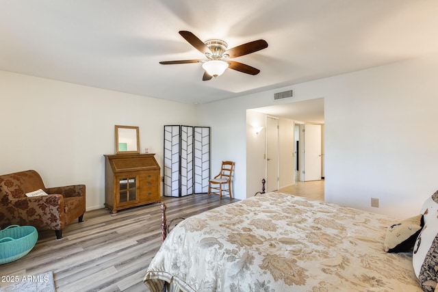 bedroom with ceiling fan and light hardwood / wood-style floors