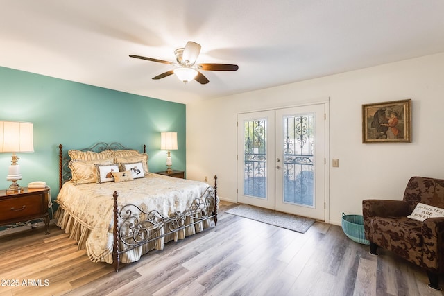 bedroom with ceiling fan, access to exterior, hardwood / wood-style flooring, and french doors