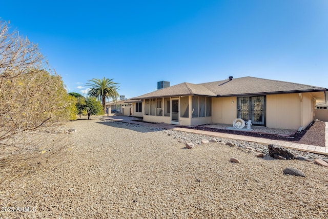 view of front of home with a sunroom and a patio