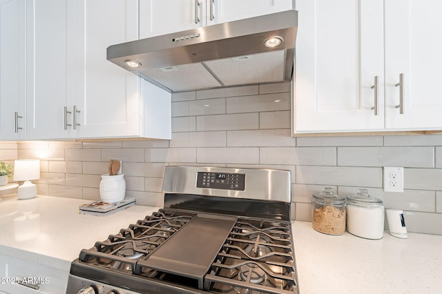 645 N Vine St, Chandler, AZ 85225 - kitchen featuring gas range, under cabinet range hood, white cabinets, tasteful backsplash, and light stone counters