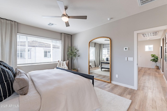 645 N Vine St, Chandler, AZ 85225 - bedroom with light wood finished floors, arched walkways, baseboards, and a ceiling fan