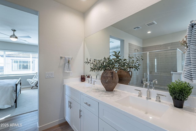 645 N Vine St, Chandler, AZ 85225 - ensuite bathroom with double vanity, a ceiling fan, a stall shower, wood finished floors, and baseboards