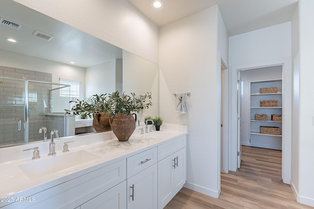 645 N Vine St, Chandler, AZ 85225 - full bath featuring double vanity, a shower stall, wood finished floors, baseboards, and recessed lighting