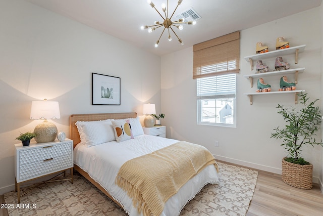 645 N Vine St, Chandler, AZ 85225 - bedroom with a chandelier, baseboards, and light wood finished floors