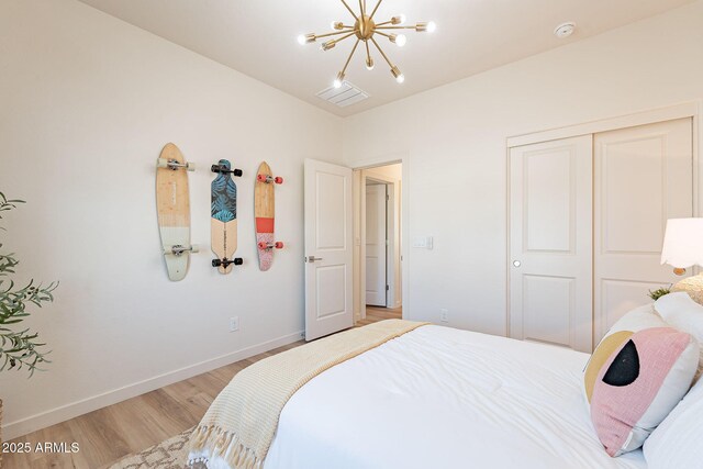 645 N Vine St, Chandler, AZ 85225 - bedroom featuring a chandelier, light wood finished floors, baseboards, and a closet