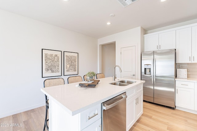 645 N Vine St, Chandler, AZ 85225 - kitchen featuring stainless steel appliances, a sink, light wood-style flooring, light countertops, and recessed lighting