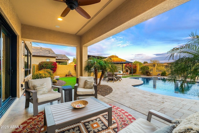 1829 N Atwood, Mesa, AZ 85207 - patio terrace at dusk with a fenced in pool, a ceiling fan, a fenced backyard, an outdoor hangout area, and a gazebo