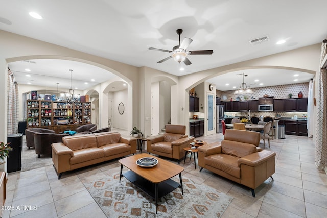 1829 N Atwood, Mesa, AZ 85207 - living room featuring arched walkways, ceiling fan with notable chandelier, light tile patterned floors, and visible vents
