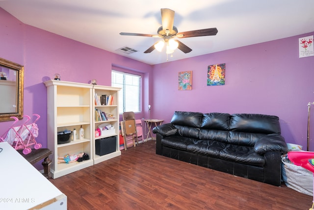 living room with dark hardwood / wood-style flooring and ceiling fan