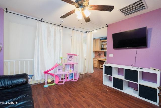 recreation room with ceiling fan and dark wood-type flooring