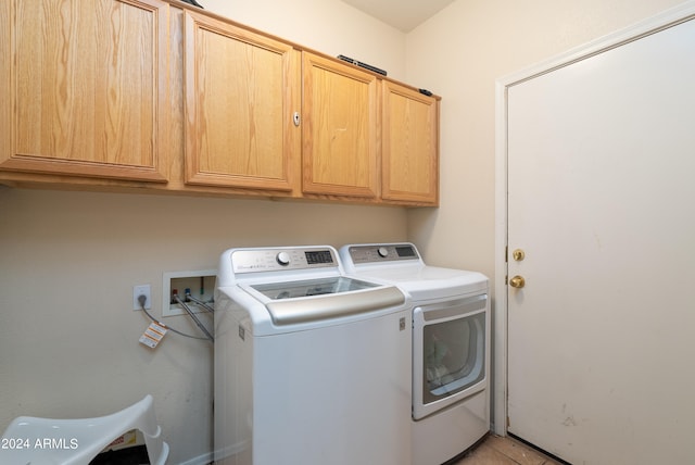 washroom with independent washer and dryer, washer hookup, cabinets, and light tile floors