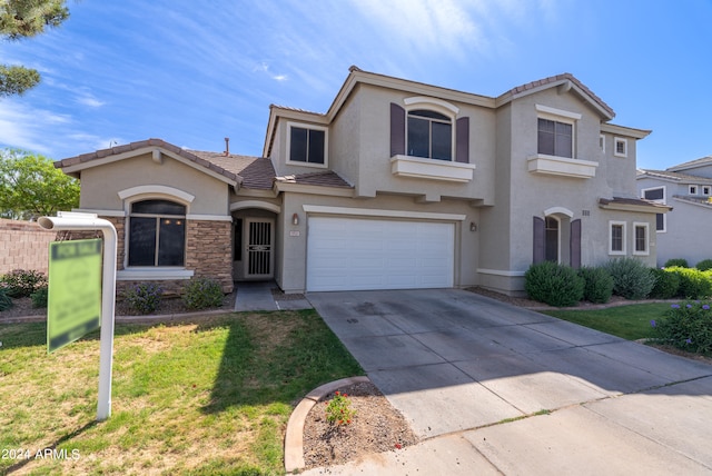 view of front facade featuring a garage and a front yard