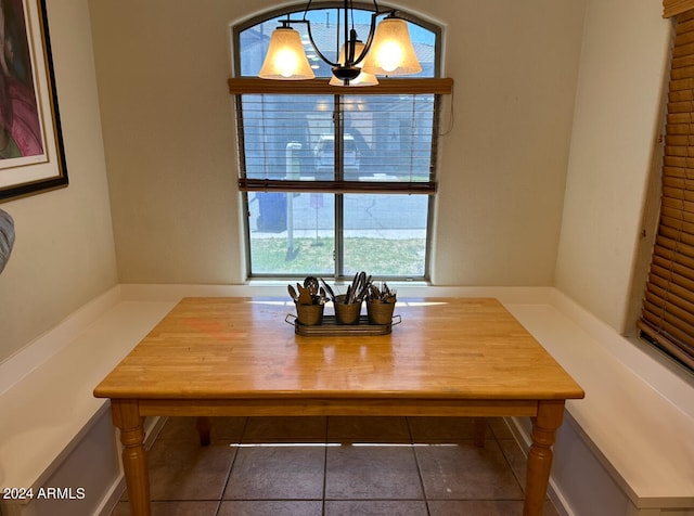 unfurnished dining area with tile floors and a chandelier