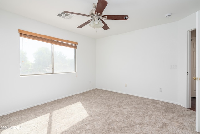 empty room featuring carpet floors and ceiling fan