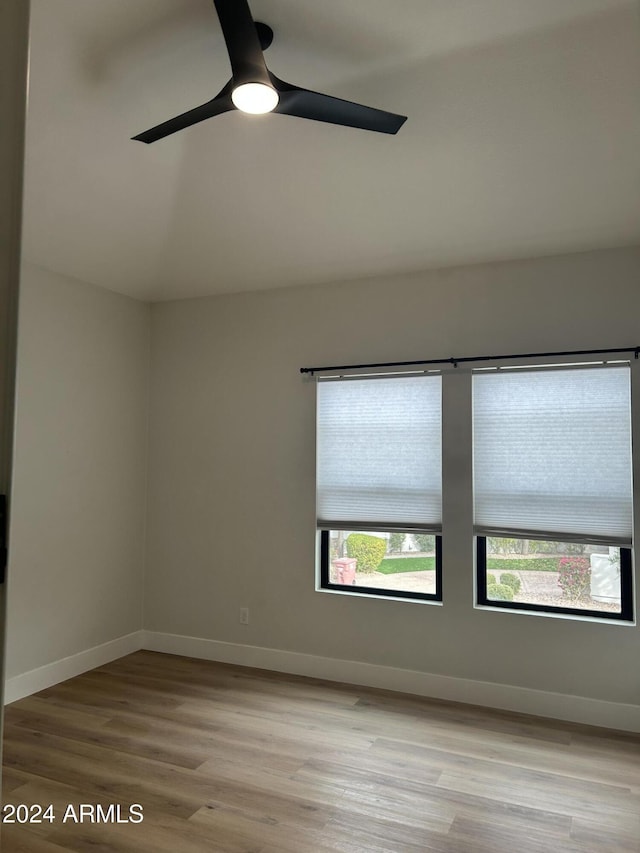 empty room featuring ceiling fan and light hardwood / wood-style flooring