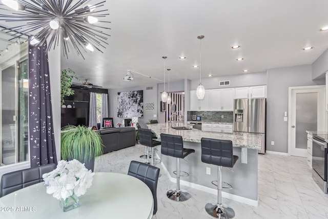 dining space with baseboards, recessed lighting, visible vents, and marble finish floor