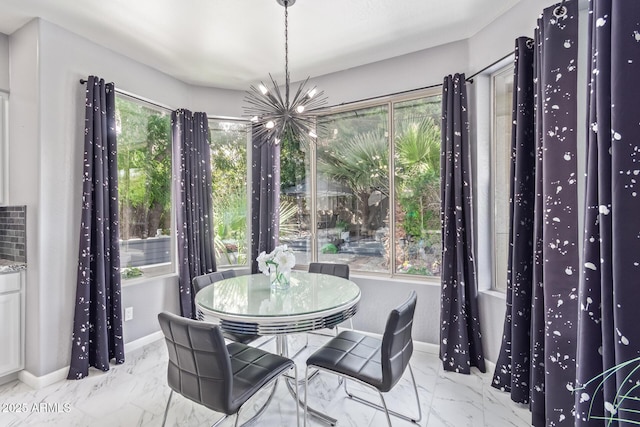 dining space with baseboards, an inviting chandelier, and marble finish floor