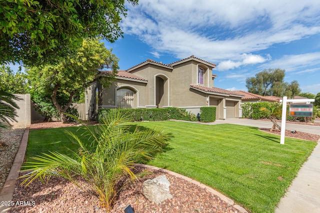 mediterranean / spanish-style house featuring stucco siding, a tiled roof, fence, driveway, and a front lawn